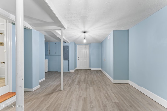 104 Carlisle Ln, Oak Ridge, TN 37830 - unfurnished living room featuring wood finished floors, baseboards, a textured ceiling, and electric panel