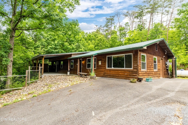 3305 Leonard Huskey Ln, Pigeon Forge, TN 37863 - view of front of property featuring driveway, faux log siding, metal roof, and a carport