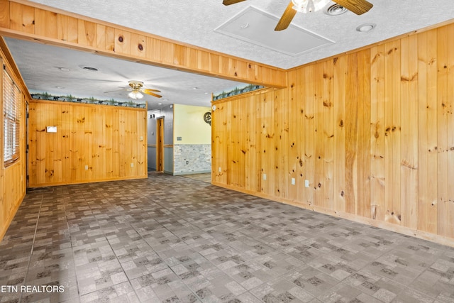 3305 Leonard Huskey Ln, Pigeon Forge, TN 37863 - empty room featuring ceiling fan, wooden walls, tile patterned floors, and baseboards