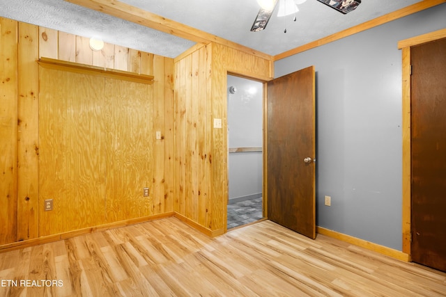 3305 Leonard Huskey Ln, Pigeon Forge, TN 37863 - unfurnished bedroom featuring wood finished floors, baseboards, wooden walls, and a ceiling fan