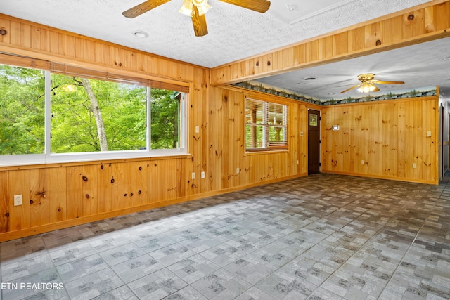 3305 Leonard Huskey Ln, Pigeon Forge, TN 37863 - unfurnished room featuring a ceiling fan, wood walls, and baseboards