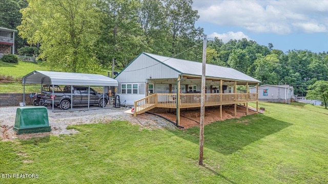 645 Blue Springs Rd, Speedwell, TN 37870 - rear view of house featuring a carport, a lawn, a wooden deck, and a wooded view