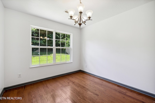 6108 Burlwood Rd, Knoxville, TN 37921 - empty room featuring a chandelier, wood finished floors, and baseboards