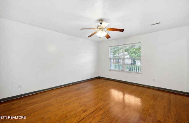 6108 Burlwood Rd, Knoxville, TN 37921 - empty room with wood finished floors, a ceiling fan, and baseboards