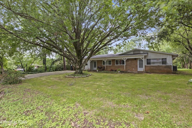 205 Newcastle Rd, Knoxville, TN 37909 - view of front facade featuring a front yard, asphalt driveway, and brick siding