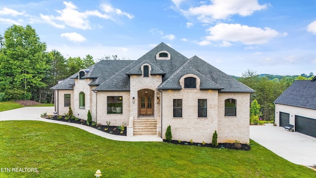 132 Rockbridge Greens Blvd, Oak Ridge, TN 37830 - french provincial home featuring brick siding, a front yard, concrete driveway, roof with shingles, and a garage