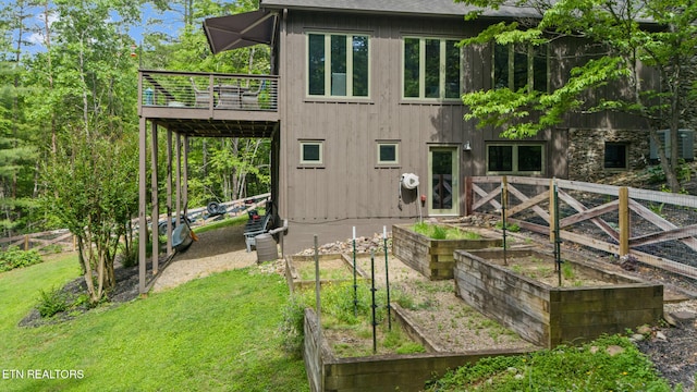 1907 Oakwood Rd, Walland, TN 37886 - rear view of house featuring a vegetable garden and a wooden deck