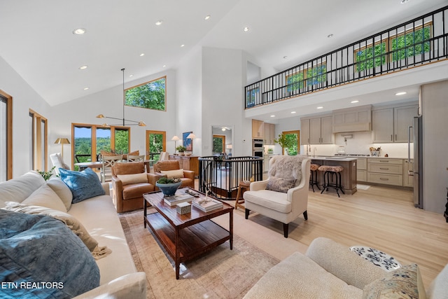 1907 Oakwood Rd, Walland, TN 37886 - living room featuring high vaulted ceiling, light wood finished floors, and recessed lighting