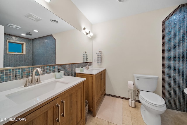 1907 Oakwood Rd, Walland, TN 37886 - bathroom with two vanities, toilet, tile patterned floors, tile walls, and a shower