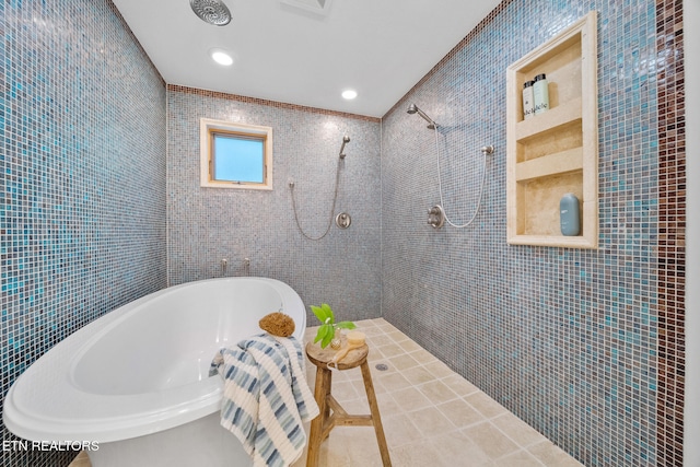 1907 Oakwood Rd, Walland, TN 37886 - bathroom featuring tile walls, a tub to relax in, a tile shower, and tile patterned floors