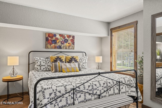 2046 Slippery Rock Cir, Sevierville, TN 37862 - bedroom with wood finished floors and a textured wall