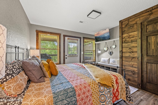 2046 Slippery Rock Cir, Sevierville, TN 37862 - bedroom featuring access to outside, wood finished floors, a textured wall, and a textured ceiling