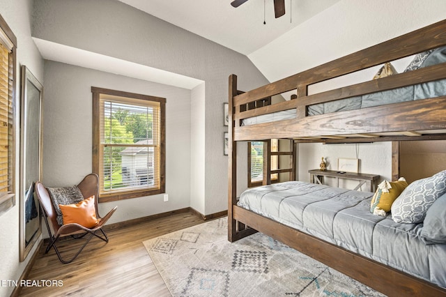 2046 Slippery Rock Cir, Sevierville, TN 37862 - bedroom with wood finished floors, vaulted ceiling, baseboards, and a textured wall
