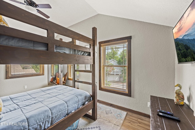 2046 Slippery Rock Cir, Sevierville, TN 37862 - bedroom with a textured wall, lofted ceiling, wood finished floors, and baseboards