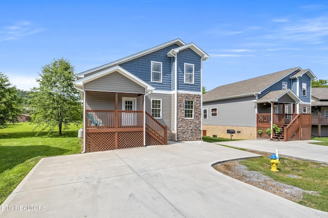 2046 Slippery Rock Cir, Sevierville, TN 37862 - view of front of house with covered porch, stairs, stone siding, and a front lawn