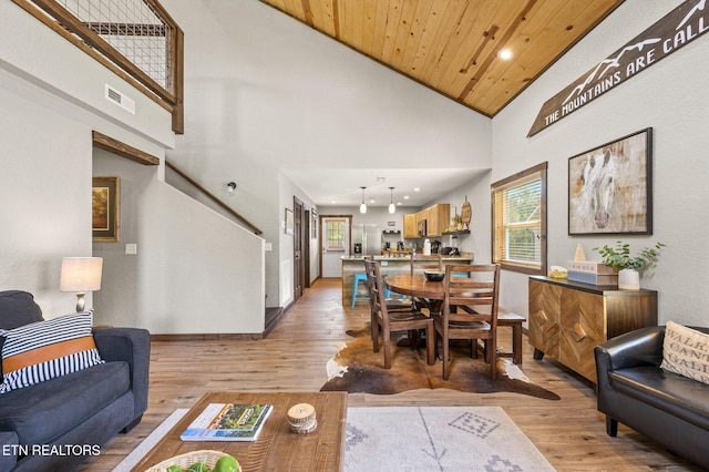 2046 Slippery Rock Cir, Sevierville, TN 37862 - living area with light wood finished floors, high vaulted ceiling, baseboards, wooden ceiling, and stairway