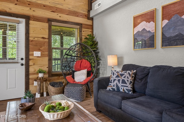 2046 Slippery Rock Cir, Sevierville, TN 37862 - living area featuring wood walls, wood finished floors, a textured wall, and plenty of natural light