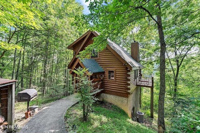 2941 Valley Springs Way, Sevierville, TN 37862 - view of side of property featuring a chimney, log siding, central AC unit, and a shingled roof