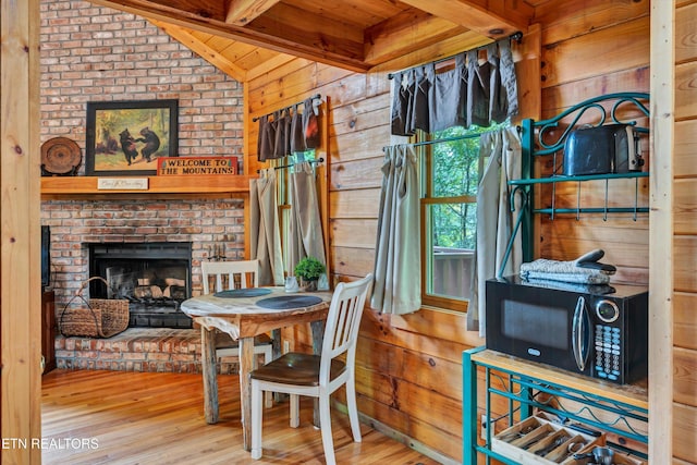 2941 Valley Springs Way, Sevierville, TN 37862 - dining space with wooden ceiling, wooden walls, wood finished floors, and a fireplace