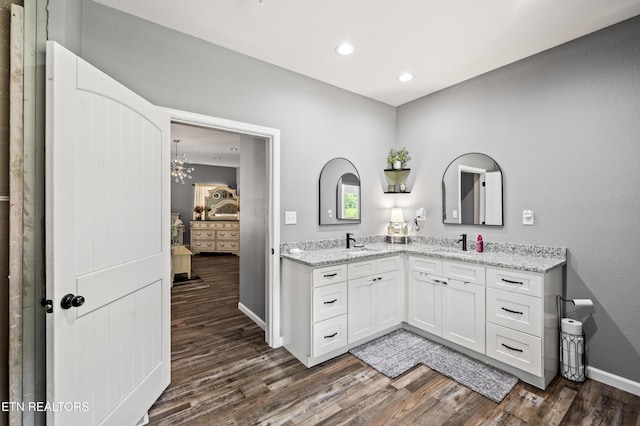 1947 Oneil Rd, Newport, TN 37821 - ensuite bathroom featuring wood finished floors, double vanity, baseboards, a chandelier, and recessed lighting