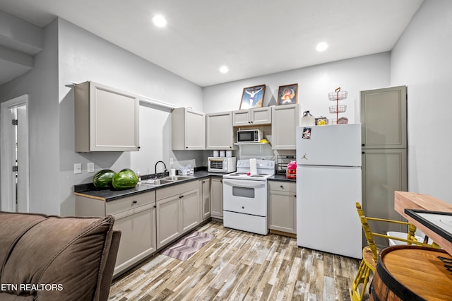 1947 Oneil Rd, Newport, TN 37821 - kitchen with white appliances, dark countertops, light wood-style flooring, a sink, and recessed lighting