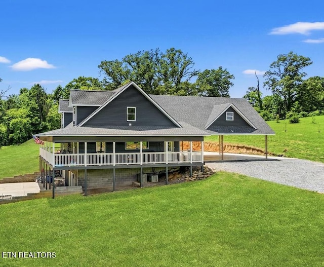 1947 Oneil Rd, Newport, TN 37821 - back of property with gravel driveway, a lawn, covered porch, and a shingled roof