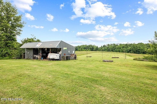 1000 Burgess Mills Rd, Cookeville, TN 38506 - view of grassy yard with an outbuilding, an outdoor structure, and view of wooded area