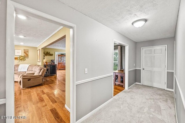 1000 Burgess Mills Rd, Cookeville, TN 38506 - hall featuring a textured ceiling, baseboards, and wood finished floors