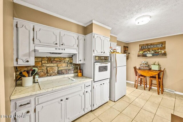 1000 Burgess Mills Rd, Cookeville, TN 38506 - kitchen featuring white appliances, under cabinet range hood, a textured ceiling, white cabinets, and light tile patterned floors