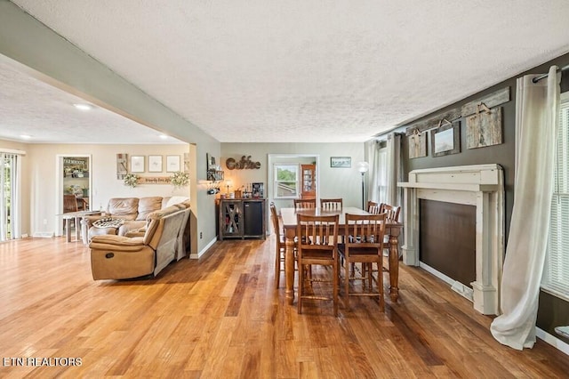 1000 Burgess Mills Rd, Cookeville, TN 38506 - dining area with a textured ceiling, wood finished floors, healthy amount of natural light, a fireplace, and baseboards