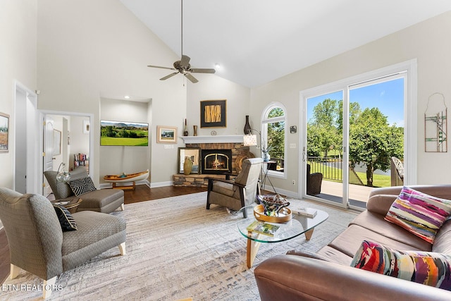 105 Gogeyi Trl, Vonore, TN 37885 - living area featuring a stone fireplace, wood finished floors, baseboards, ceiling fan, and high vaulted ceiling