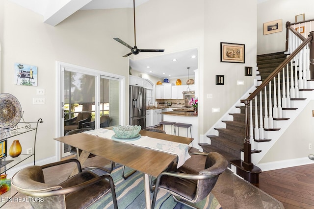 105 Gogeyi Trl, Vonore, TN 37885 - dining area featuring baseboards, ceiling fan, a towering ceiling, stairway, and wood finished floors