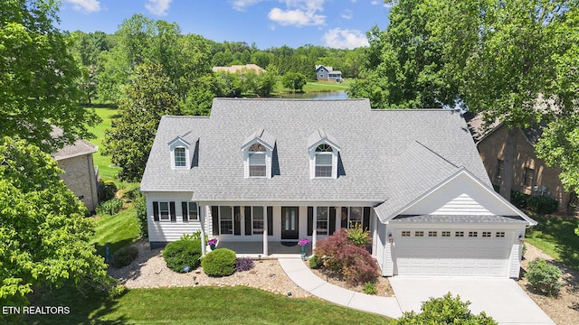 105 Gogeyi Trl, Vonore, TN 37885 - new england style home with concrete driveway, a garage, roof with shingles, a front yard, and a porch