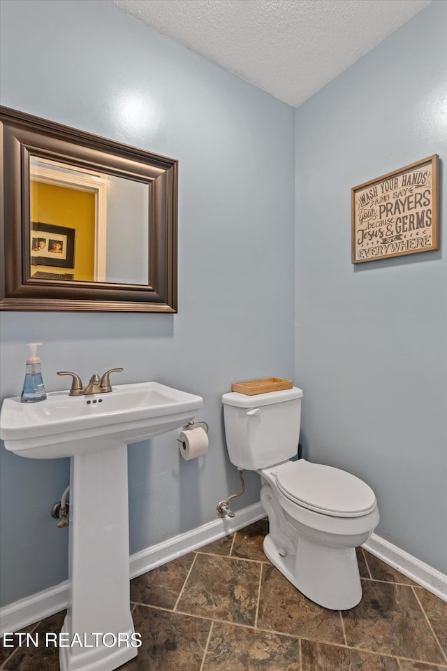 1420 Brentwood Dr, Athens, TN 37303 - half bath with toilet, baseboards, a textured ceiling, and a sink