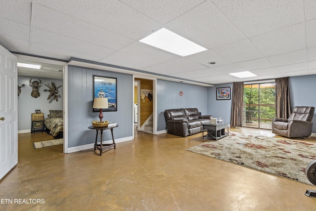 1420 Brentwood Dr, Athens, TN 37303 - living room featuring finished concrete flooring, a paneled ceiling, baseboards, and stairs