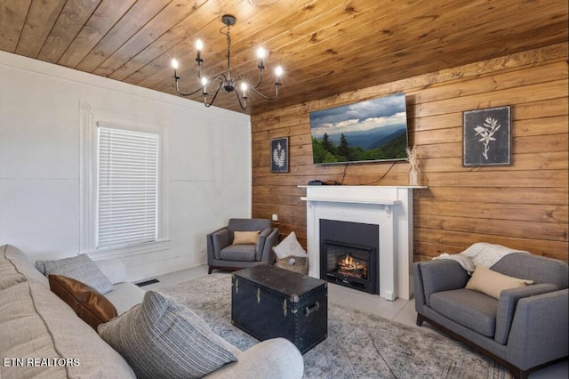 525 S Carter School Rd, Strawberry Plains, TN 37871 - living room featuring wood ceiling, wood walls, a chandelier, a lit fireplace, and tile patterned flooring