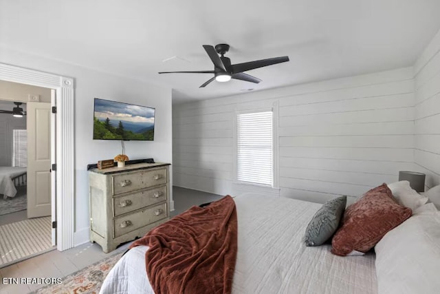 525 S Carter School Rd, Strawberry Plains, TN 37871 - bedroom with ceiling fan, wood walls, and wood finished floors