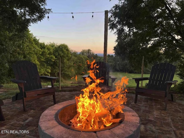 525 S Carter School Rd, Strawberry Plains, TN 37871 - patio terrace at dusk with an outdoor fire pit and a patio area