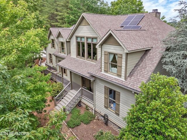 670 Hawk View Dr, Townsend, TN 37882 - view of front of home featuring a shingled roof, a chimney, roof mounted solar panels, and stairs