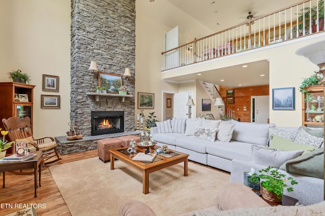 670 Hawk View Dr, Townsend, TN 37882 - living area with a high ceiling, wood finished floors, a stone fireplace, and stairs
