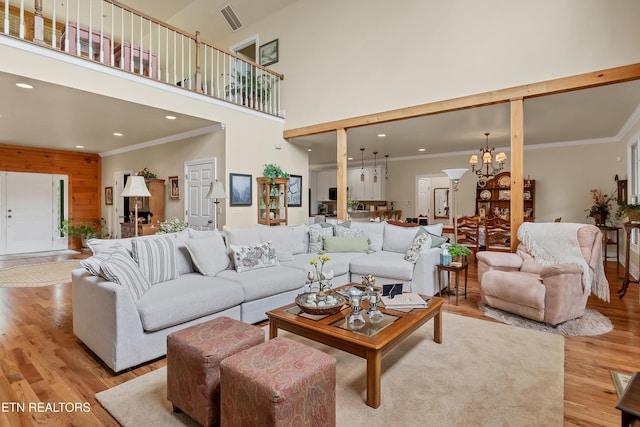 670 Hawk View Dr, Townsend, TN 37882 - living room with light wood-style floors, a chandelier, crown molding, a high ceiling, and recessed lighting