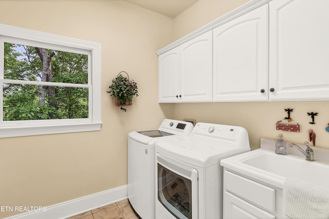 670 Hawk View Dr, Townsend, TN 37882 - laundry room with cabinet space, washing machine and dryer, baseboards, and light tile patterned floors