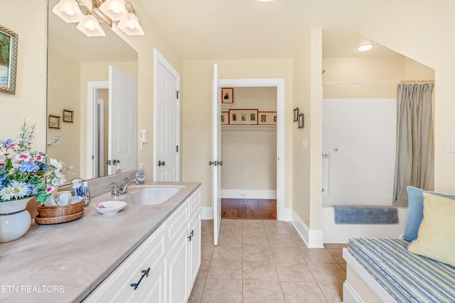 670 Hawk View Dr, Townsend, TN 37882 - bathroom featuring vanity, shower / bathtub combination with curtain, tile patterned floors, and baseboards