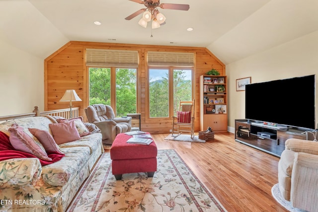670 Hawk View Dr, Townsend, TN 37882 - living room with vaulted ceiling, wood walls, healthy amount of natural light, wood finished floors, and ceiling fan