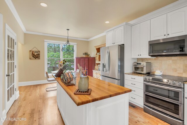 670 Hawk View Dr, Townsend, TN 37882 - kitchen featuring stainless steel appliances, wooden counters, white cabinets, decorative backsplash, and crown molding