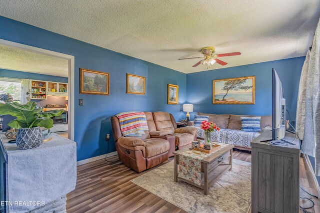 159 Little Creek Ln, Lafollette, TN 37766 - living area with ceiling fan, wood finished floors, a textured ceiling, and baseboards