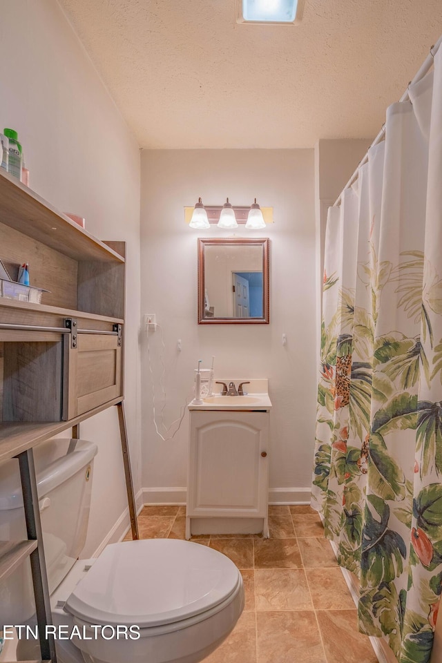 159 Little Creek Ln, Lafollette, TN 37766 - full bathroom featuring toilet, vanity, a textured ceiling, baseboards, and a shower with curtain