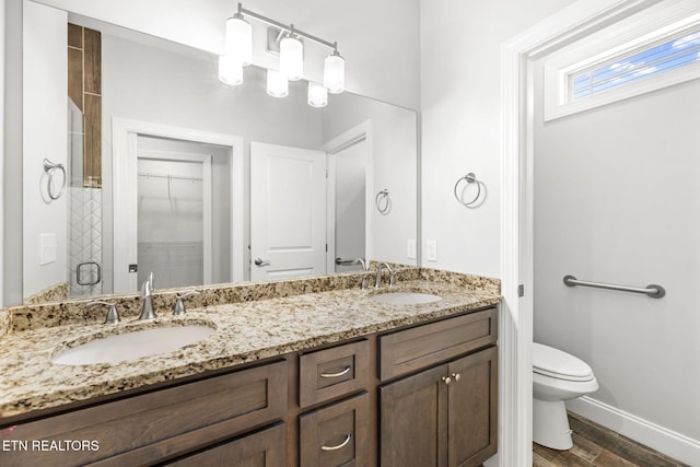 115 Tsuhdatsi Way, Loudon, TN 37774 - full bathroom with double vanity, toilet, wood finished floors, baseboards, and a spacious closet