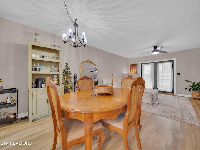 633 Vose Rd Unit G, Alcoa, TN 37701 - dining area with a chandelier, light wood-style flooring, a ceiling fan, and baseboards