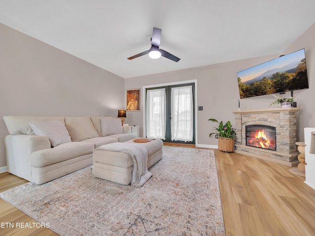 633 Vose Rd Unit G, Alcoa, TN 37701 - living area featuring wood finished floors, a ceiling fan, a fireplace, and baseboards